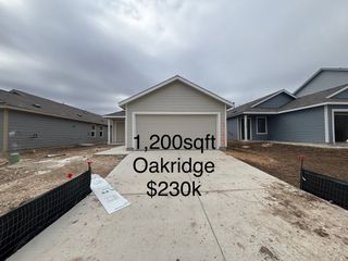 Street view A modern single-story home with a spacious garage in Brookmill: Brookstone II Collection by Lennar (San Antonio, TX).