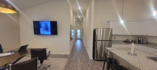 Model Home A modern kitchen and dining area with stainless appliances, granite countertops, and sleek furnishings.