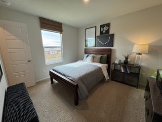 A charming bedroom with a cheerful color palette, rustic wall decor, and a cozy window view, perfect for a relaxing retreat.