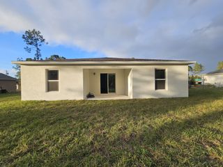 A modern white home with a spacious backyard in Marion Oaks by Century Complete (Ocala, FL).