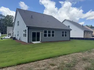 A modern gray home with a spacious backyard in Candleberry Place by Lennar (Sharpsburg, GA).