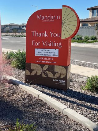 A welcoming street sign at Mandarin at Citrus Park by Landsea Homes, set in a landscaped community in Goodyear, AZ.