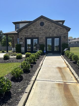 A charming brick home with manicured hedges in Chapel Run by Lennar (Montgomery, TX).