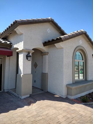 Charming stucco home with elegant arches and a tiled roof in Redwood Valley at Prasada by Fulton Homes (Surprise, AZ).