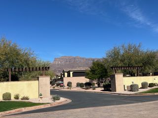 A picturesque community with desert landscaping and mountain views in Club Village at Superstition Mountain by Bellago Homes (Gold Canyon, AZ).