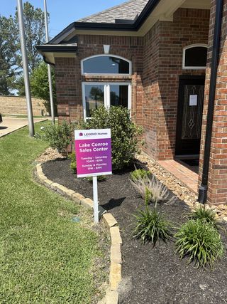 Elegant brick home with manicured landscaping in Walden on Lake Conroe by Legend Homes (Montgomery, TX).