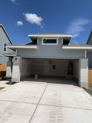 A modern garage with sleek siding and fresh white bricks in Eastwood at Sonterra by Lennar (Jarrell, TX).