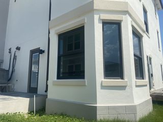 Street view A modern white townhome with expansive windows and sleek design in Pelican View Townhomes by A-Team Petroleum Construction (Jacksonville Beach, FL).