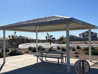 A scenic park pavilion with a picnic table in Zanjero Pass by D.R. Horton, Waddell, AZ.