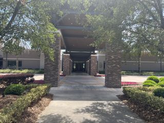 Community Amenities A brick-columned entrance with lush landscaping in Ocala Preserve by D.R. Horton, offering modern charm in Ocala, FL.