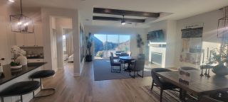 A modern dining area with sleek furniture, large windows, and cozy decor creating an inviting, well-lit space.