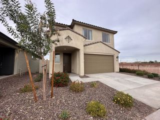 Street view A charming two-story home with a spacious garage and landscaped yard in Beacon Hill at Marley Park by Homes by Towne (Surprise, AZ).