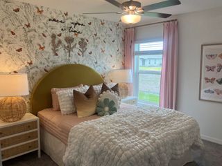 A whimsical bedroom with butterfly-themed wallpaper, a cozy bed, pastel decor, and soft lighting for a serene atmosphere.