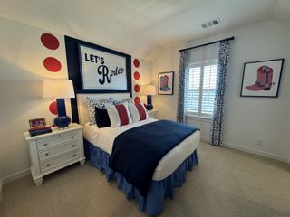 A cozy bedroom with a rodeo theme, featuring vibrant decor, stylish artwork, and a comfortable bed with colorful pillows.