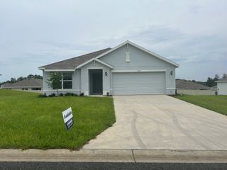 A spacious new construction with a welcoming driveway and well-groomed front yard in Huntington Ridge by D.R. Horton (Ocala, FL).