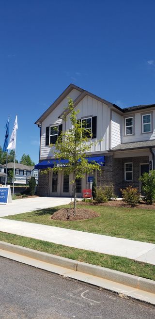Elegant home with a brick facade and lush landscaping in Timber Ridge: Timber Ridge 42' by Lennar (Douglasville, GA).