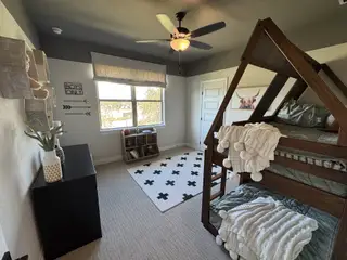 A cozy kid's room with a fun wooden bunk bed, playful decor, and neutral tones for a stylish yet inviting atmosphere.