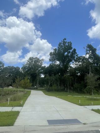 A serene wooded pathway in the Indigo Grove Single Family Homes by Stanley Martin Homes (Johns Island, SC).