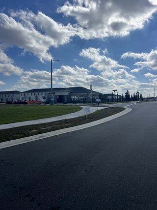 A modern community entrance with spacious roads and sidewalks at Danbury at Ridgewood Lakes by D.R. Horton (Davenport, FL).