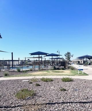 Street view Community pool with shaded seating and landscaped grounds at Bella Vista Trails Estate Series by Meritage Homes (San Tan Valley, AZ).