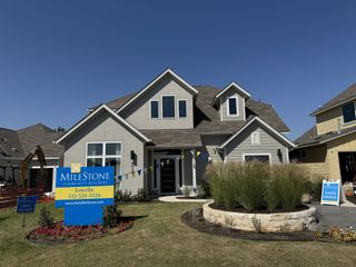 Street view A charming home with a manicured lawn in Loyola by Milestone Community Builders, Austin, TX.