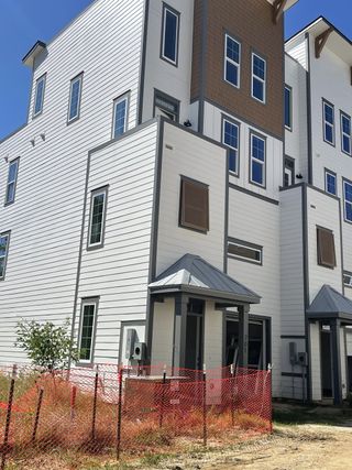 Street view A modern townhouse with sleek lines and large windows in Walk at Park Circle by CK Development (North Charleston, SC).