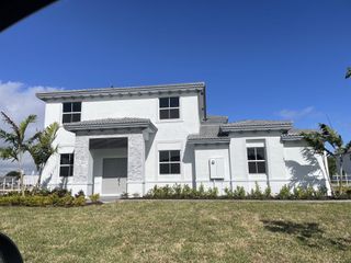 Street view A modern white home with a neat lawn in Silverland Estates by Lennar (Miami, FL).