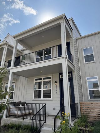 Street view A contemporary two-story home with a cozy porch and modern design in Mueller 11 - 22.5 X 90 Row Home by Lennar (Austin, TX).