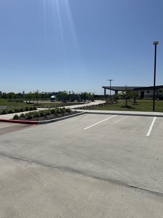 A spacious community park with a playground and covered pavilion in Newport Pointe by D.R. Horton (Crosby, TX).