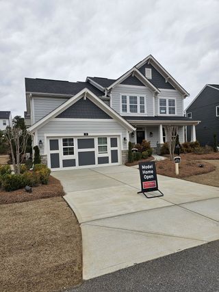A gorgeous gray craftsman-style home with charming accents in Twin Lakes by Fischer Homes (Hoschton, GA).