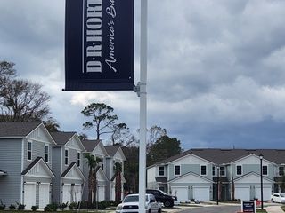 Modern townhomes with double garages and lush landscaping in West Ortega Landing by D.R. Horton (Jacksonville, FL).