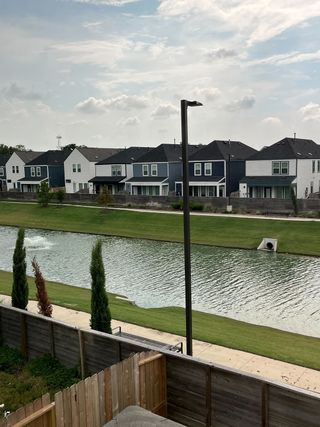 Charming homes with waterfront views and lush greenery in Cay Landing by First America Homes (Houston, TX).