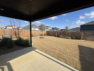 Model Home Private backyard with a freshly landscaped lawn, perfect for outdoor living and entertaining.