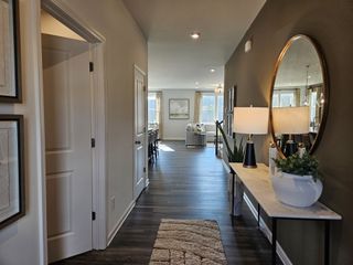 Model Home A stylish bathroom with a glass-enclosed shower, dual sinks, and modern tile in Red Hawk Landing by HistoryMaker Homes (San Antonio, TX).