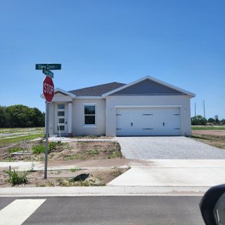 A modern single-story home with a two-car garage in Yucatan Gardens by CFB Homes, Azalea Park, FL.