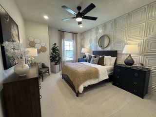A cozy bedroom with a textured accent wall, warm lighting, chic decor, and a plush carpet for ultimate comfort and style.