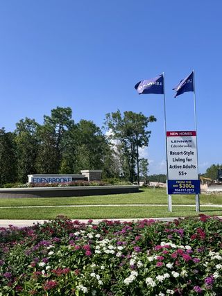 A vibrant landscaped entrance with colorful flowers welcomes you to Edenbrooke at Hyland Trail by Lennar (Green Cove Springs, FL).