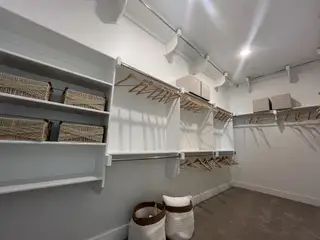 A spacious walk-in pantry with built-in shelving, perfect for storage and organization in Solterra Texas by Cadence Homes (Mesquite, TX).