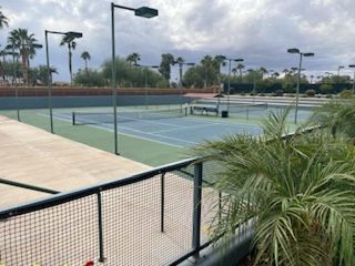 Tennis courts amid palm trees in Robson Ranch Arizona by Robson Resort Communities (Eloy, AZ).