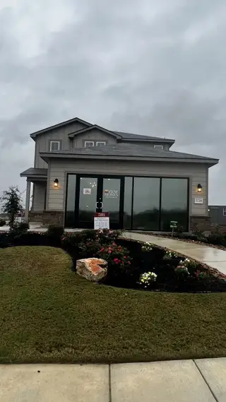 A modern home with large windows and a beautifully landscaped front yard in Blue Ridge Ranch by View Homes (San Antonio, TX).