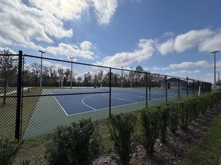 Community tennis courts under a bright blue sky in Storey Creek: Estate Collection by Lennar, Kissimmee, FL.