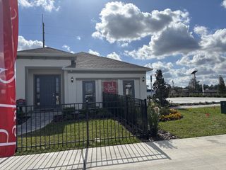 Street view A modern home with sleek design and manicured lawn in Highfield at Twisted Oaks by Park Square Residential (Wildwood, FL).