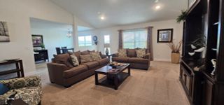 A cozy living room with plush brown sofas, patterned cushions, and elegant decor creating an inviting atmosphere.