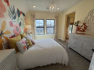 A cheerful bedroom with a floral accent wall, bohemian-style decor, and soft, neutral tones, making it a perfect retreat.