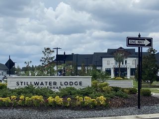 Lennar's Stillwater - Villas in St. Johns, FL, showcases a beautifully landscaped lodge with modern architecture.