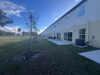 Street view Modern row of homes backing onto green space in Oak Creek Preserve by Maronda Homes (Lakeland, FL).