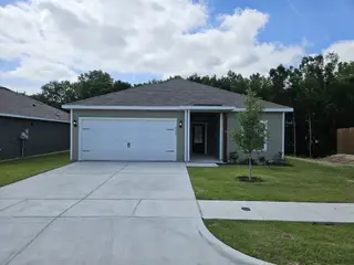 Street view A modern single-story home with a spacious driveway and neat landscaping in College Park by LGI Homes (Dallas, TX).