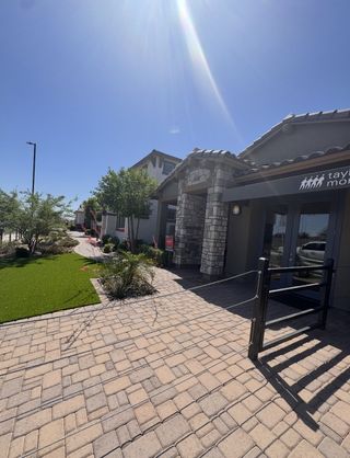 Beautiful modern home with stone accents and landscaped entry in Hawes Crossing Landmark Collection by Taylor Morrison (Mesa, AZ).