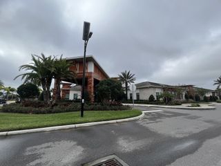 Community Amenities Scenic drive towards the Mirada Active Adult community entrance, with well-maintained grounds and palm trees lining the way (San Antonio, FL).