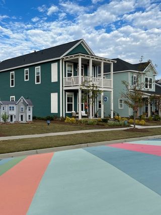 A charming teal home with a double balcony in Nexton - Midtown - The Park Collection by David Weekley Homes (Summerville, SC).